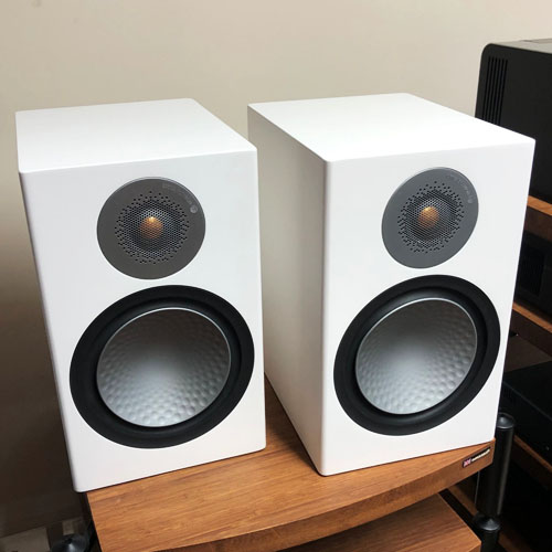 Two Monitor Audio Silver speakers on the table